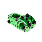 The Eclat Burns Stem is a green anodized CNC-machined 6061-T6 alloy BMX stem with a black splatter finish, four black bolts, and a front load design, shown on a white background.