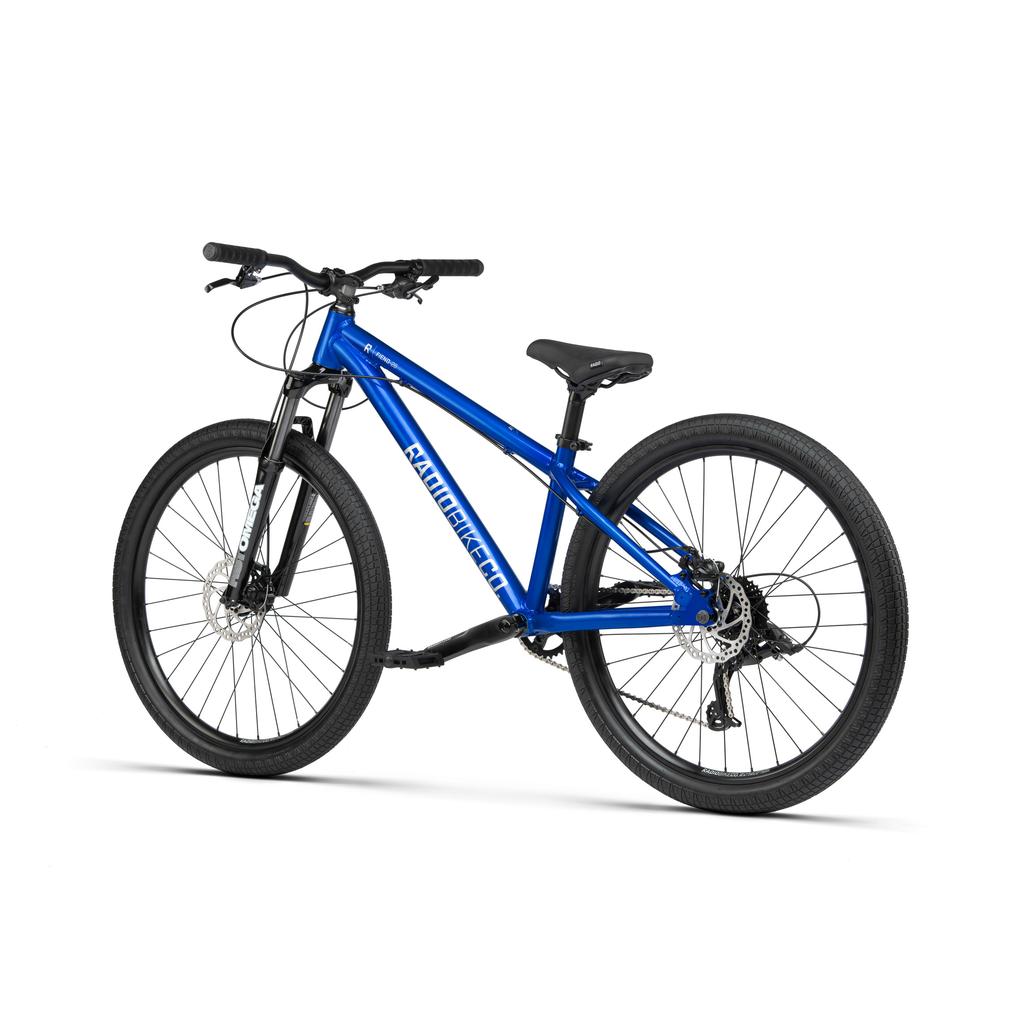A blue Radio Fiend 26 Inch Bike with front suspension, disc brakes, flat handlebars, and knobby tires is displayed against a white background.