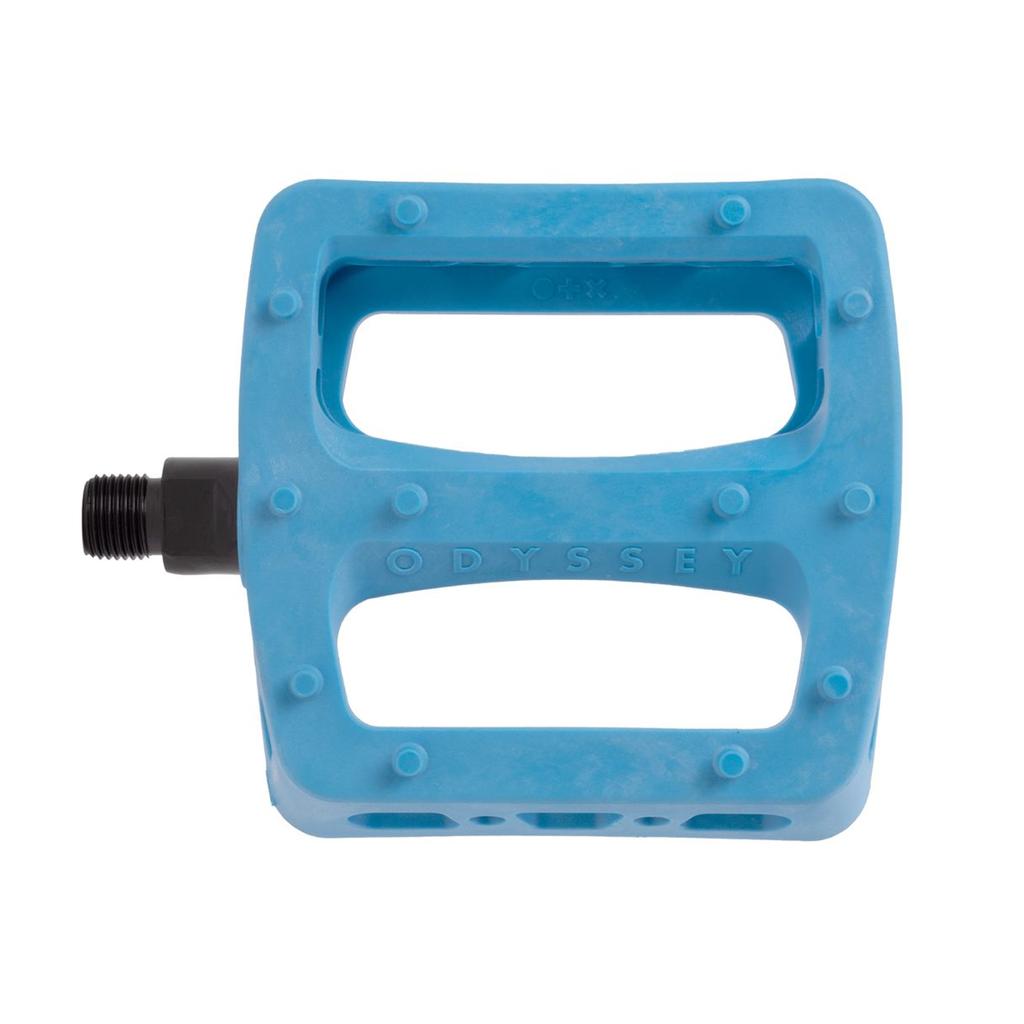 A blue Odyssey Twisted PC Pro Pedal, crafted from durable nylon composite with a rectangular design and two large cutouts, is shown from above—ideal for BMX riders who want both style and performance.