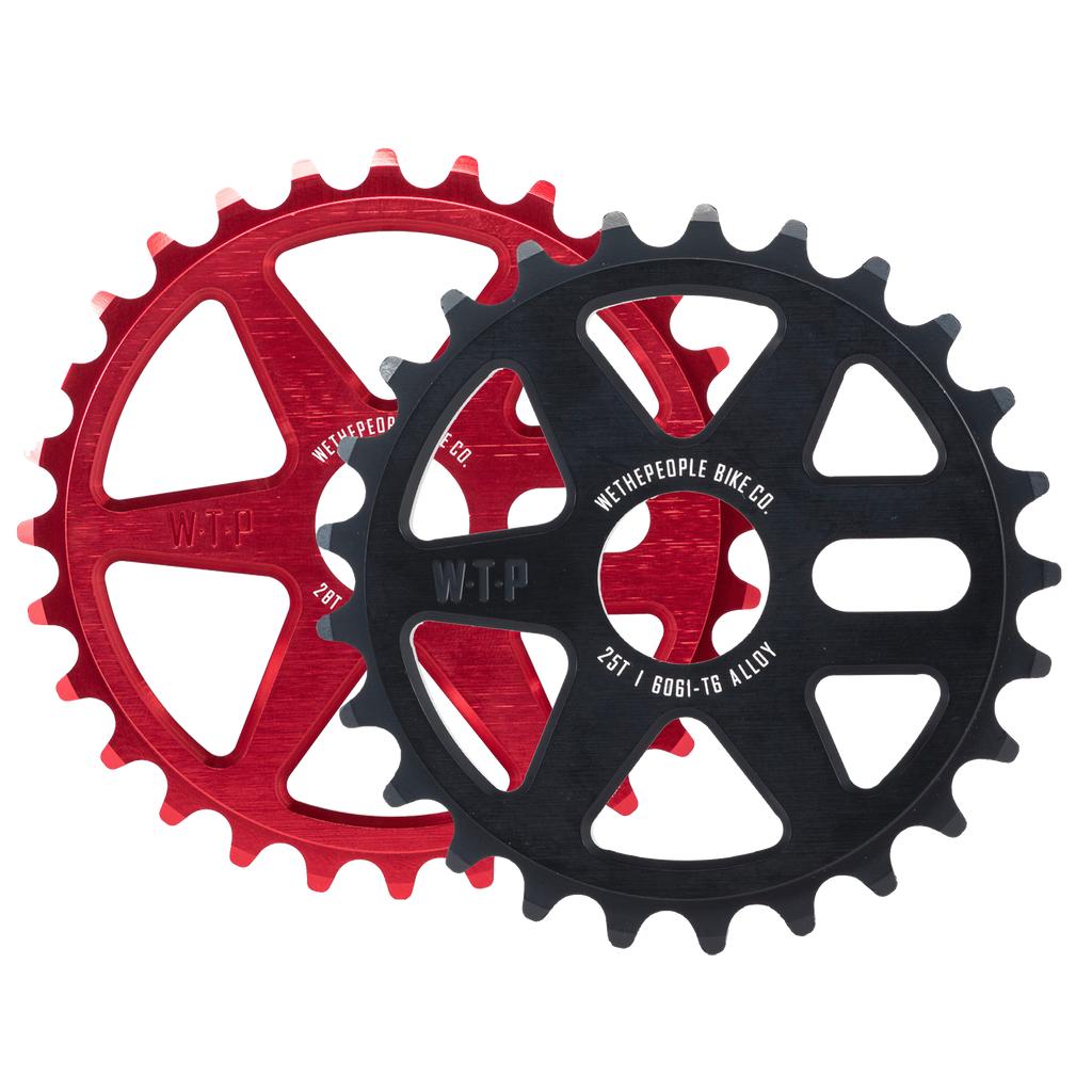 The Wethepeople Logic Sprocket comes in red and black with cutout spoke designs and labeled specs—perfect for BMX riders seeking a quality upgrade.