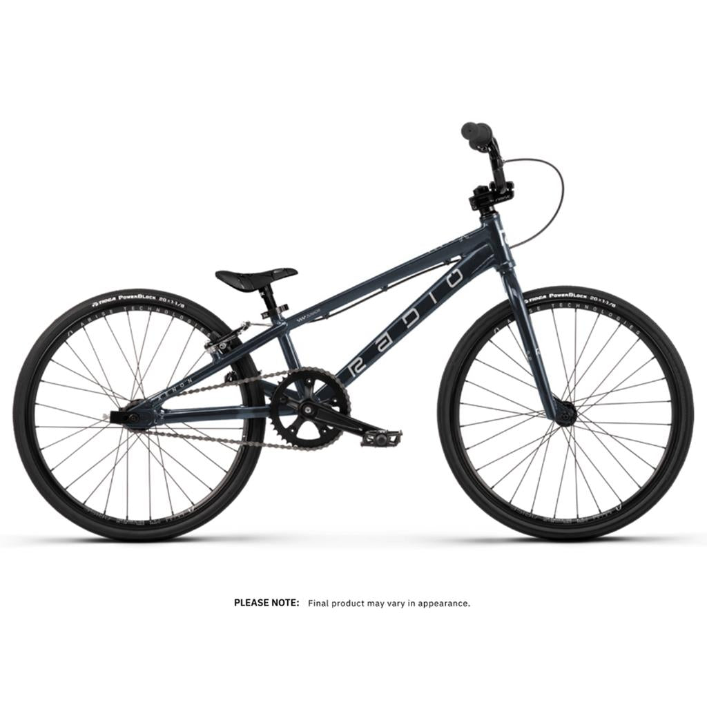 The Radio Xenon Junior 20 Inch Bike is a blue BMX race bike with a compact hydroformed 6061-T6 alloy frame, black seat, and slim Tioga Power Block tyres, shown in profile against a white background.