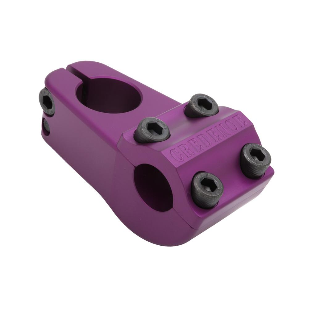 The S&M Turtleneck Stem is a purple BMX stem with a 52mm reach, four black hex bolts on the front, and "CREDENCE" engraved on top.