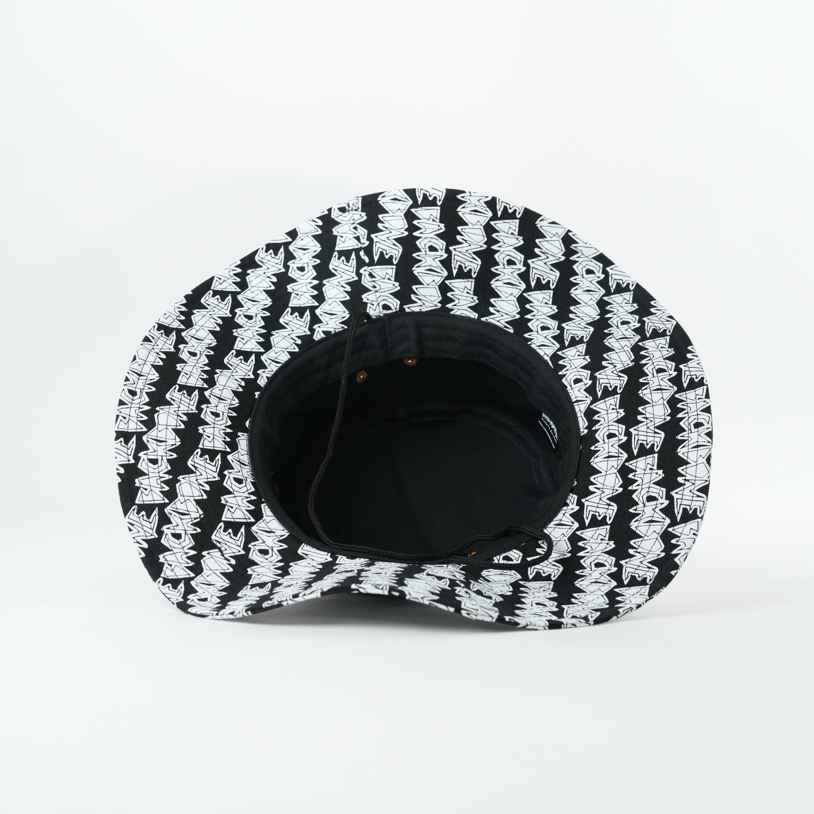 The Backbone AO Boonie is a black bucket hat featuring a white graffiti-style pattern, inspired by Backbone BMX, shown from above on a plain white background.