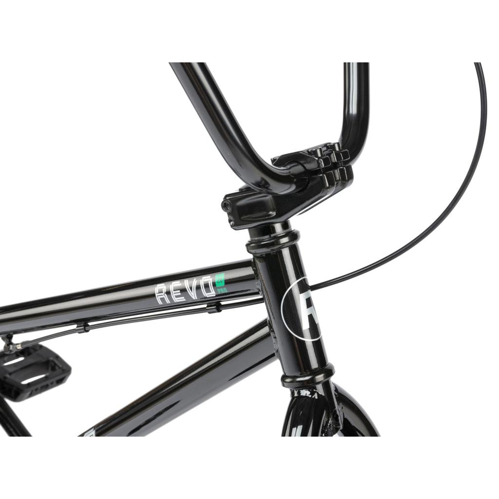Close-up view of the black Radio Revo Pro 20 Inch Bike’s handlebars, stem, and frame with "REVO" branding on the top tube, highlighting its Rookie Three Piece Cranks.