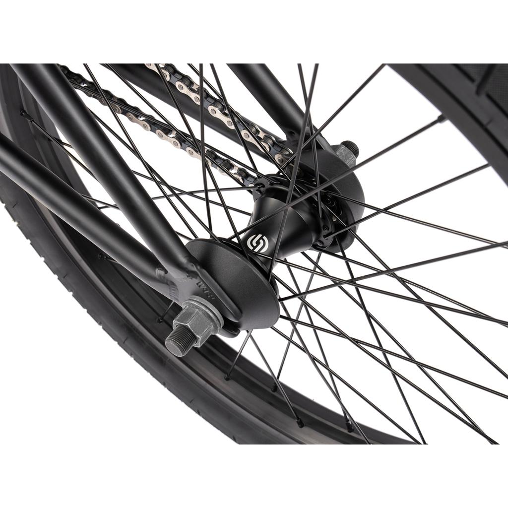 Close-up of the Wethepeople Arcade 20 Inch Bike rear wheel hub, spokes, chain, and frame dropout featuring Salt Valon rims.