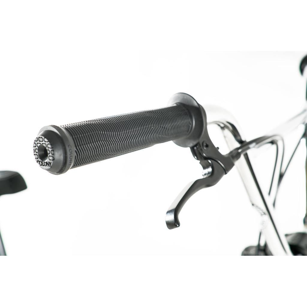Close-up of the Colony Prody Pro 20 Inch Bike's handlebar grip and brake lever against a white background, highlighting features typical of mid school BMX builds.