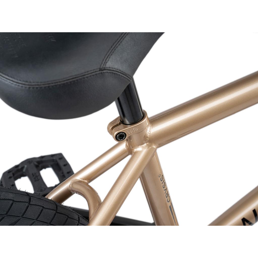 Close-up of the Wethepeople Crysis 20 Inch BMX Bike seat, SaltPlus seat post clamp, and rear tire, showcasing its metallic frame finish.