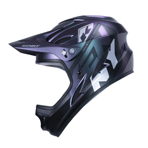 The Kenny Racing Downhill Helmet / Prisme is a black and purple motocross helmet with bold geometric patterns, a visor, and an injected plastic shell. It's Australian Certified for safety standards.