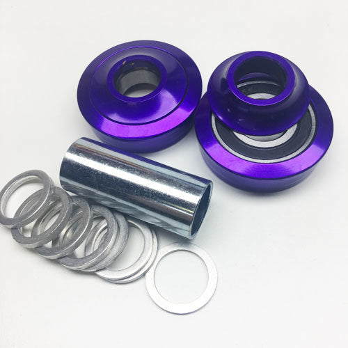 A set of Purple Profile USA Bottom Bracket Kit bearings and rings on a white surface, featuring sealed bearings.