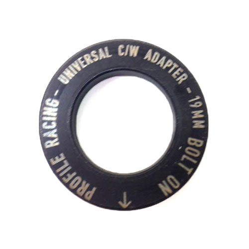 A black circular adapter ring with the text "PROFILE RACING - UNIVERSAL C/W ADAPTER - 19MM BOLT ON" inscribed around the edge, compatible with Profile Sabre Sprocket Insert.
