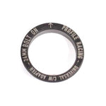 Close-up of a black circular metal adapter engraved with "PROFILE RACING - UNIVERSAL CMW ADAPTER - 24MM BOLT ON," designed for seamless integration with the Profile Sabre Sprocket Insert.