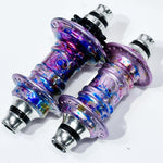 The Profile Mini Front & Rear Hub Set (LE-Galaxy Rust) features a metallic, iridescent finish with blue, pink, and purple splashes—an Anthony Napolitan signature design shown on a white background.