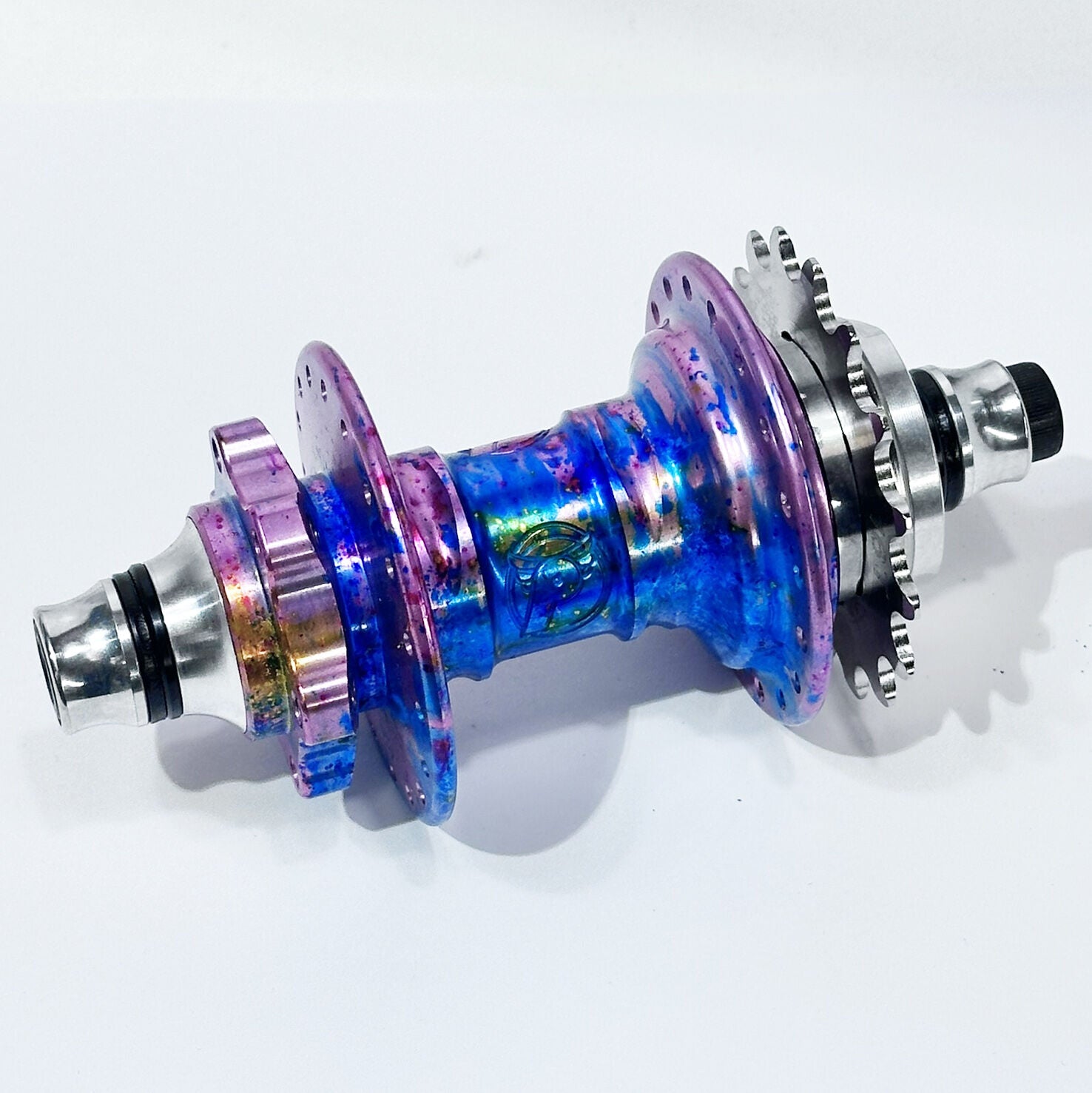 The Profile Mini Front & Rear Hub Set (LE-Galaxy Rust) / Disc Brake is a metallic, multi-colored BMX hubset with sprockets and axle, shown against a white background and featuring disc brake compatibility.
