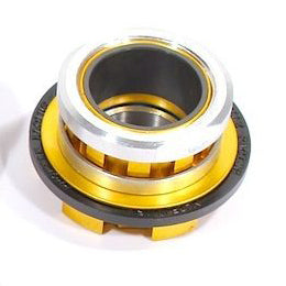 A close-up view of a metal Profile Elite Cassette Driver (15-20mm) with gold anodized, silver, and gray components, similar to splined cogs used in BMX hubs for mechanical or automotive applications.