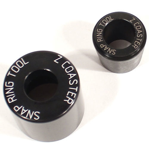 Two cylindrical metal tools, called "Profile Snap Ring Tool (Suit Z-Coaster)," with one larger than the other, rest elegantly on a white surface. These essential installation tools efficiently handle spiral retaining rings.