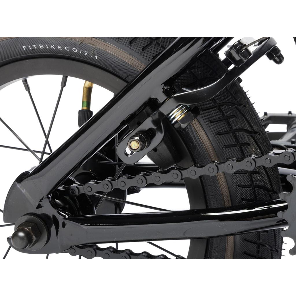 Close-up of the Fit Misfit 12 Inch Bike’s rear wheel, highlighting the tire, chain, frame, and braking system designed for beginner BMX riders.