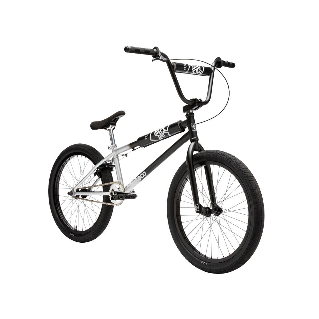 The Fit Bike Co Series 22 Inch Bike, shown from the left at an angle, features a black and silver frame, padded seat, thick tires, and straight handlebars.