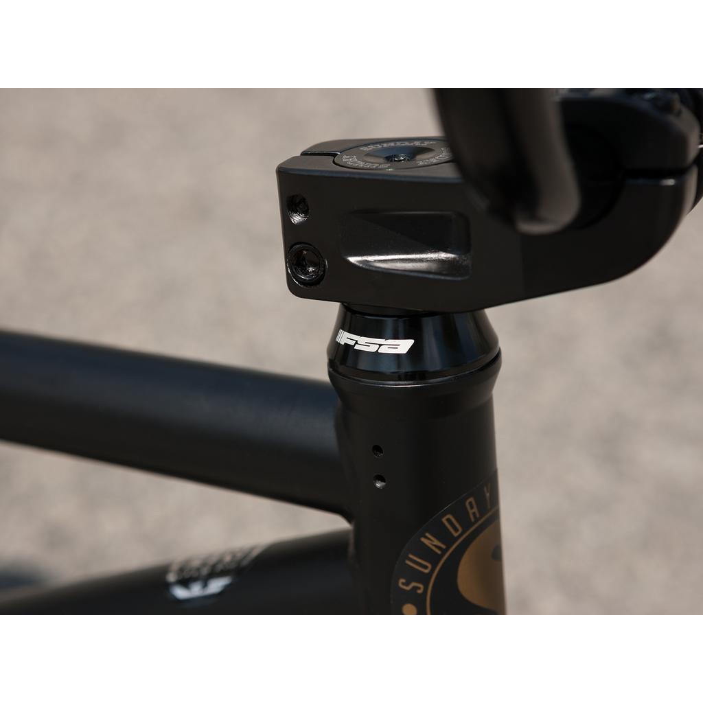 Close-up of a black FSA-branded stem and headset on the Sunday Forecaster 20 Inch Bike (2025) / Broc Raiford, with a 100% chromoly frame and "Sunday" logo, photographed outdoors.