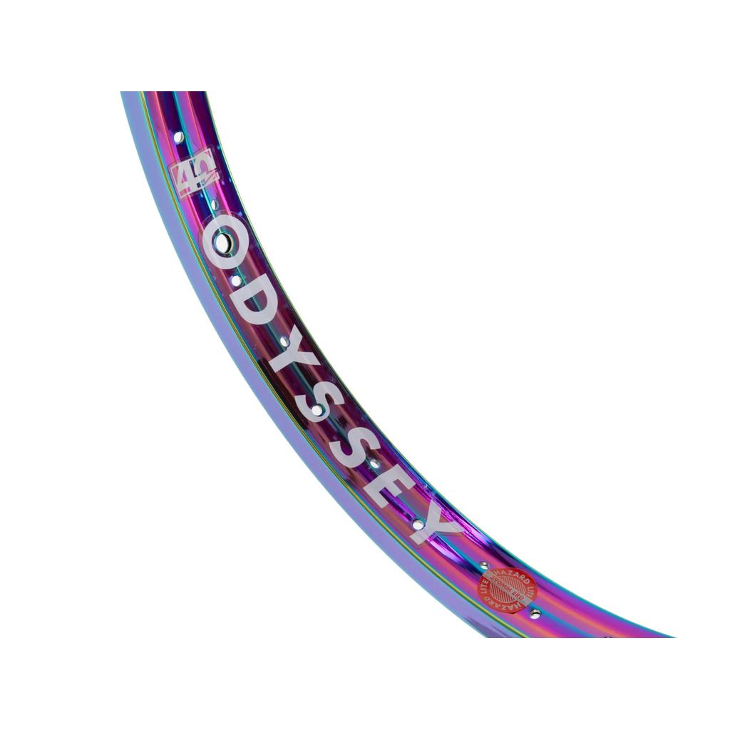 A close-up of the Odyssey Hazard Lite 40th Anniversary Rim features a reflective, multicolored finish with "ODYSSEY" prominently displayed in white letters.