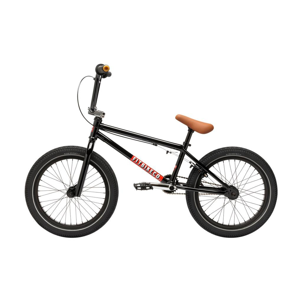 The Fit Bike Co Misfit 18 Inch Bike features a black frame with "FITBIKECO." branding, a brown seat, black handlebars with orange grips—perfect for kids seeking a stylish and high-performance BMX ride.