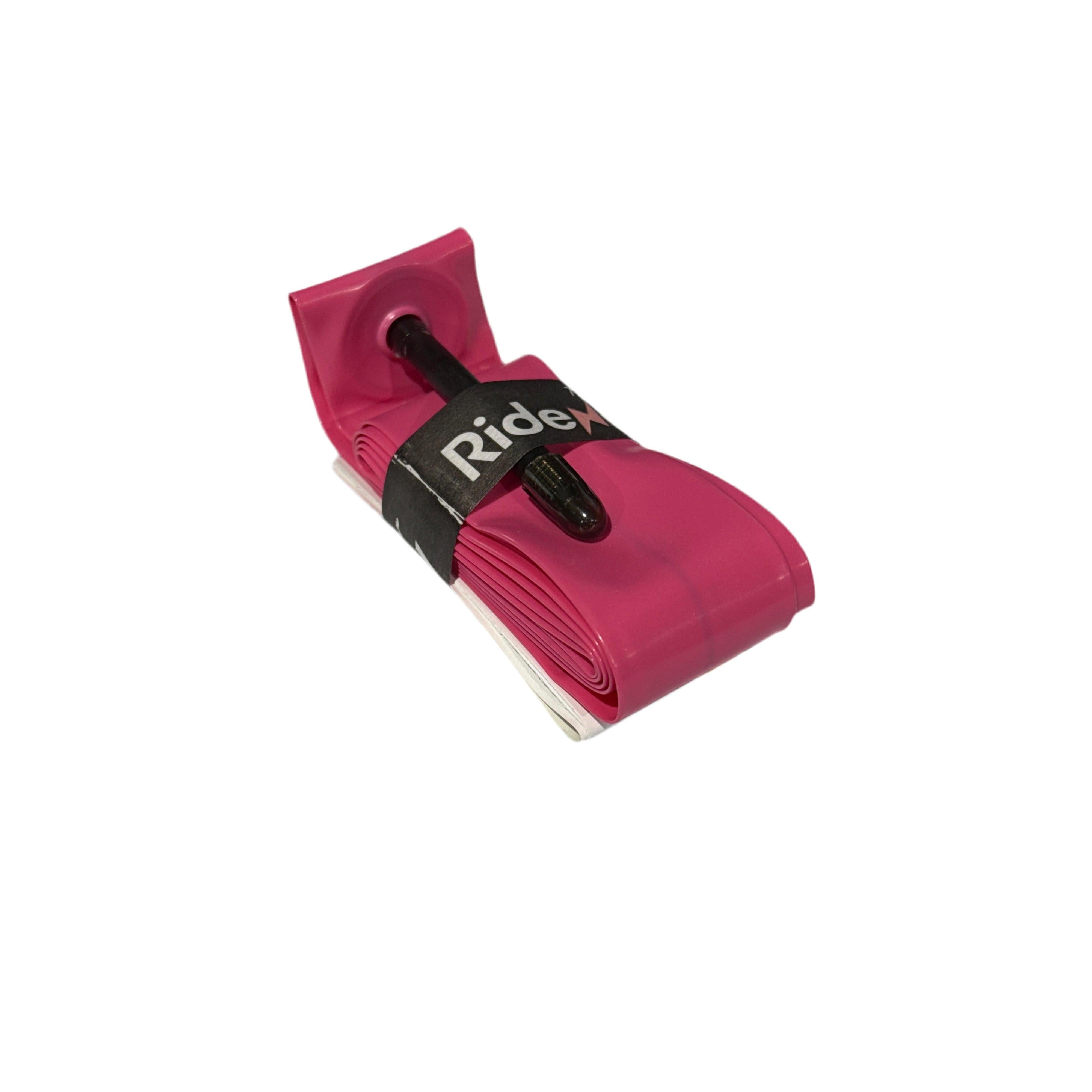 A folded pink RideNow TPU 20 Inch Tube (406mm) with a black Presta (French) valve, secured by a black "RideX" strap, displayed on a white background.