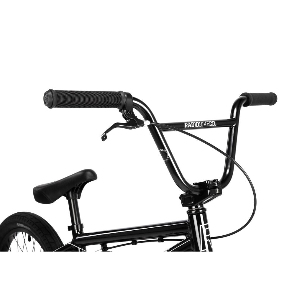 Close-up of the black Radio Dice 18 Inch Bike, showcasing its handlebars, brake lever, seat, and rear wheel with Salt Tracer Tyres against a white background.