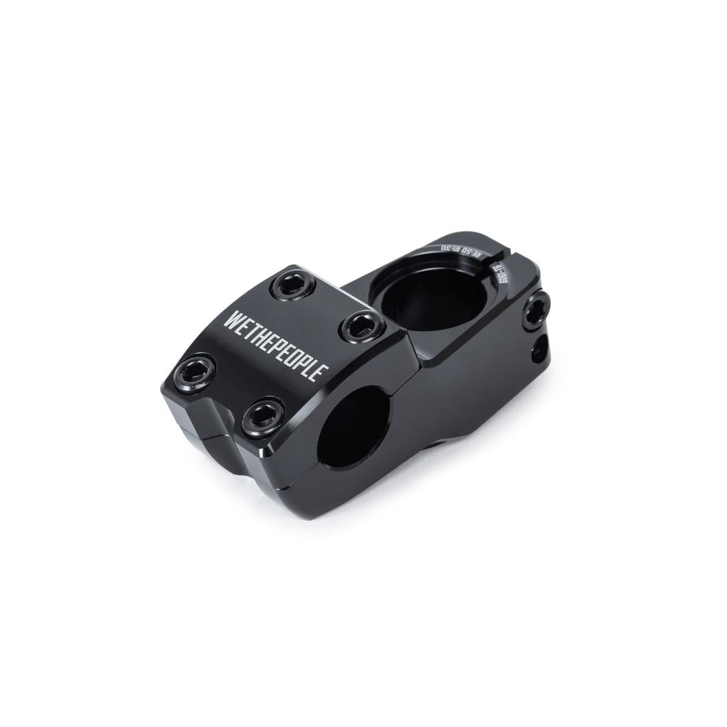 The Wethepeople Hydra Stem (25.4mm Clamp) is a black metal BMX stem featuring Shark Tooth Clamping, WeThePeople branding, four front bolt holes, and two clamp sections for handlebars and fork.