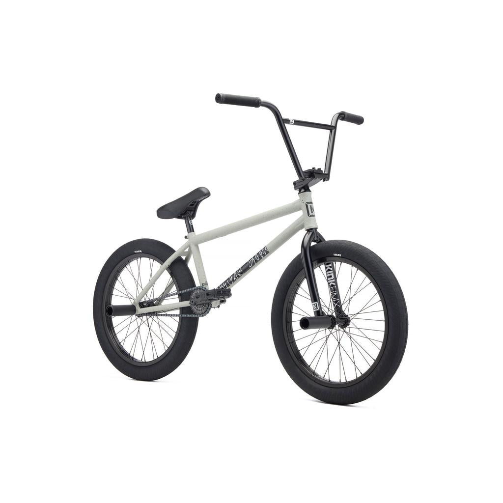 The Kink Switch 20 Inch Bike (2027) features a gray and black frame, thick tires, padded seat, straight handlebars, and durable chromoly construction, all displayed against a white background.