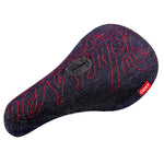 The Odyssey Big Stitch Pivotal Seat is a black canvas BMX seat with dark denim fabric, red embroidered script, and a small red "ODSY" tag on the side for style and durability.