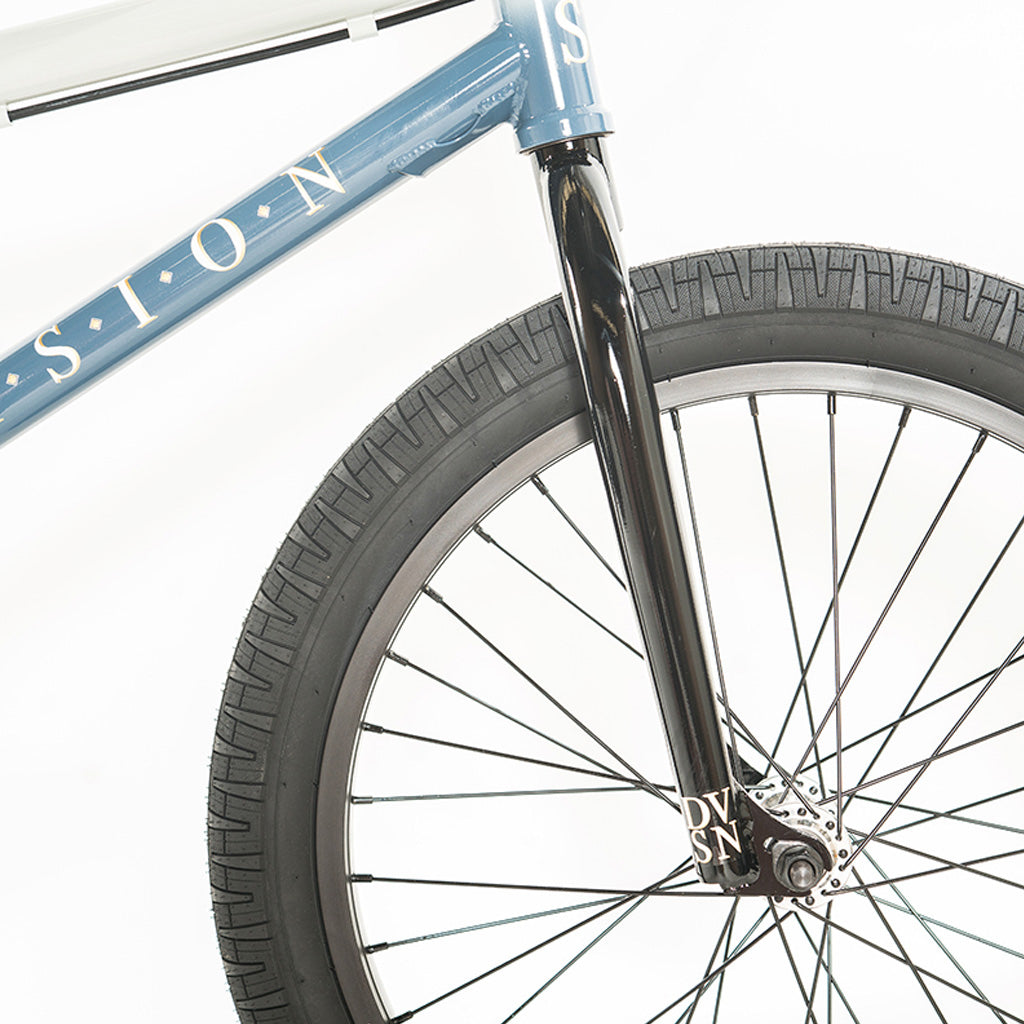 The Division Reark 20 Inch Bike, a blue BMX bike, is showcased with its sleek design and standout features. The bike is captured against a clean white background, highlighting the impressive Division Reark 20 Inch Bike.