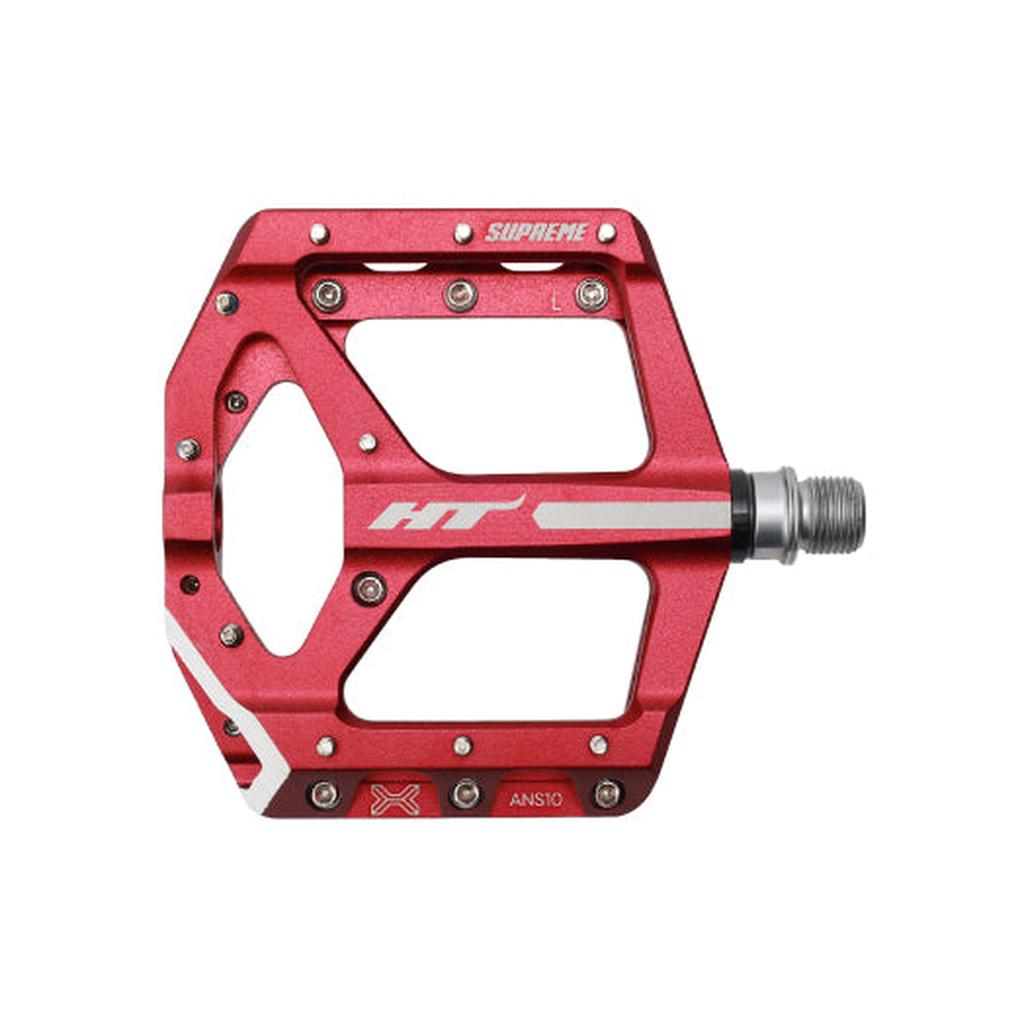 HT Supreme ANS10 Pedals feature a red alloy body, wide open design, metal pins for grip, and "HT" and "SUPREME" branding—delivering top race-level flat pedal performance.