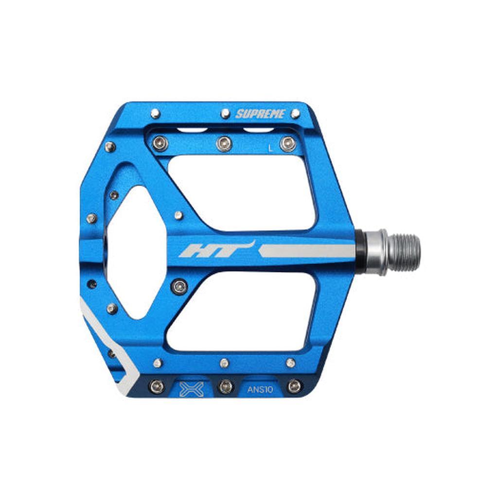 The HT Supreme ANS10 Pedals feature a blue alloy body with silver accents, multiple traction pins, and visible "HT" and "SUPREME" branding—making them a top choice for race-level flat pedal performance.