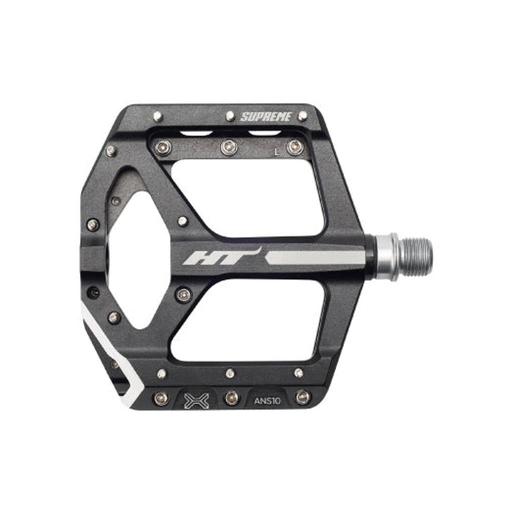 The HT Supreme ANS10 Pedals are black, wide-platform alloy flat pedals with metal pins for grip and a silver spindle.