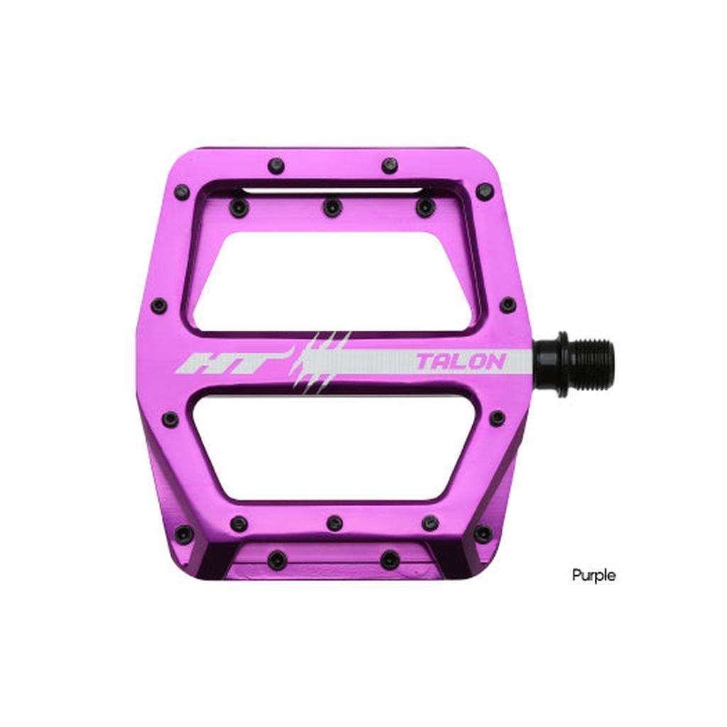 The HT AN71 Talon Pedals are shown in purple with multiple grip pins and a black spindle, set against a white background.