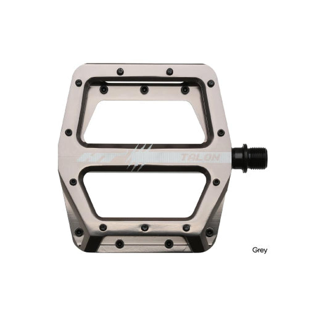 The HT AN71 Talon Pedals are grey metal bicycle flat pedals featuring a wide, rectangular platform, multiple screw-in traction pins, and a central spindle for attachment.