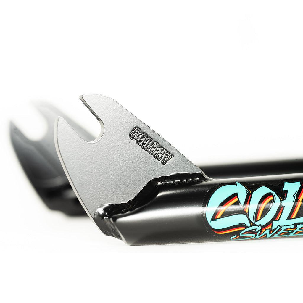 A close up of Colony Sweet Tooth Forks, a black bike handlebar with a logo on it, emphasizing durability and riding styles.
