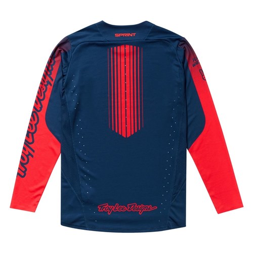 The TLD 25.2 Sprint Jersey / Segment Midnight features a navy blue body, red sleeves, vertical red back stripes, and bold "Troy Lee Designs" branding.