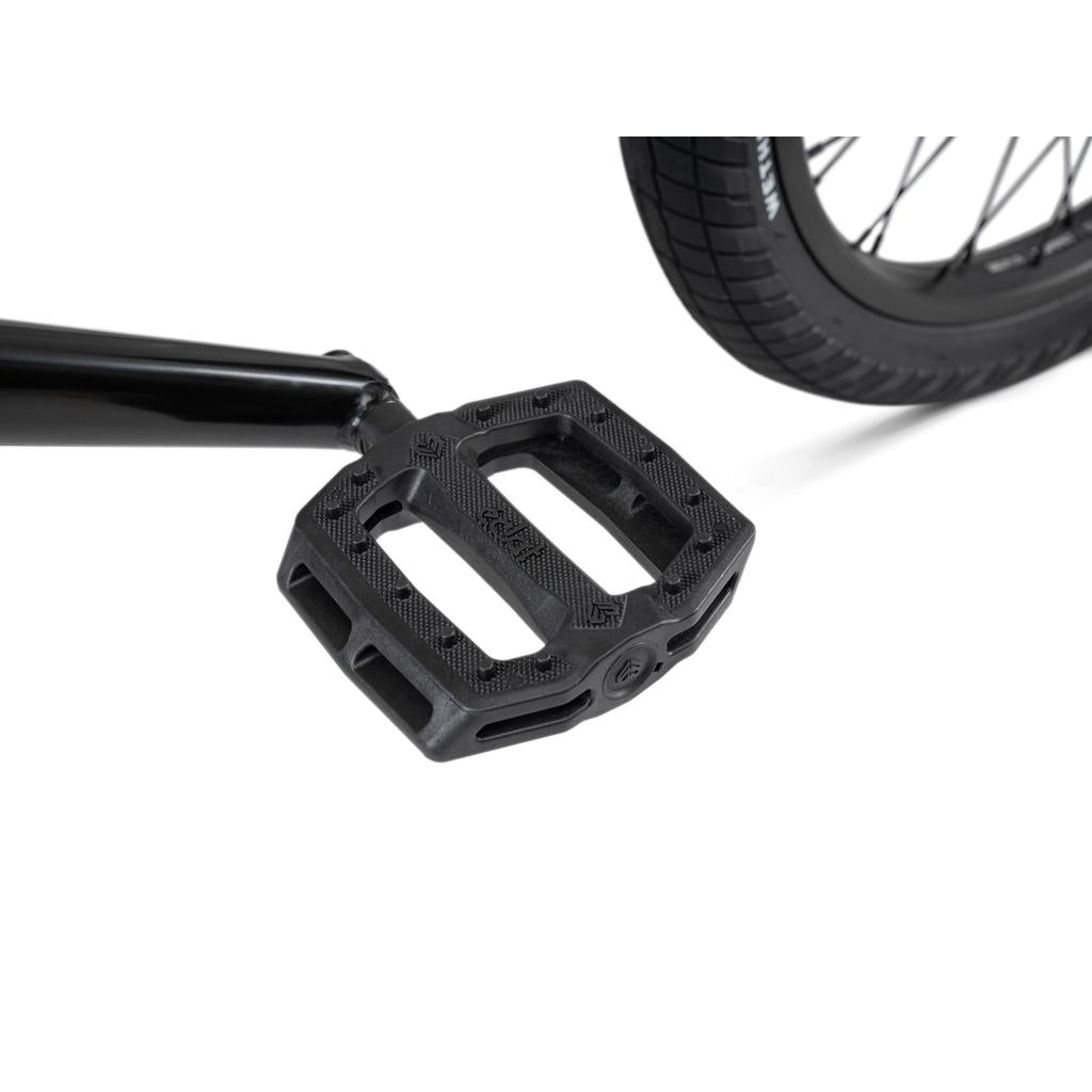 Close-up of a black plastic pedal on SaltPlus Ultra Three Piece Cranks, with part of the rear wheel and Overbite Tyres in the background on a Wethepeople Crysis 20 Inch BMX Bike.