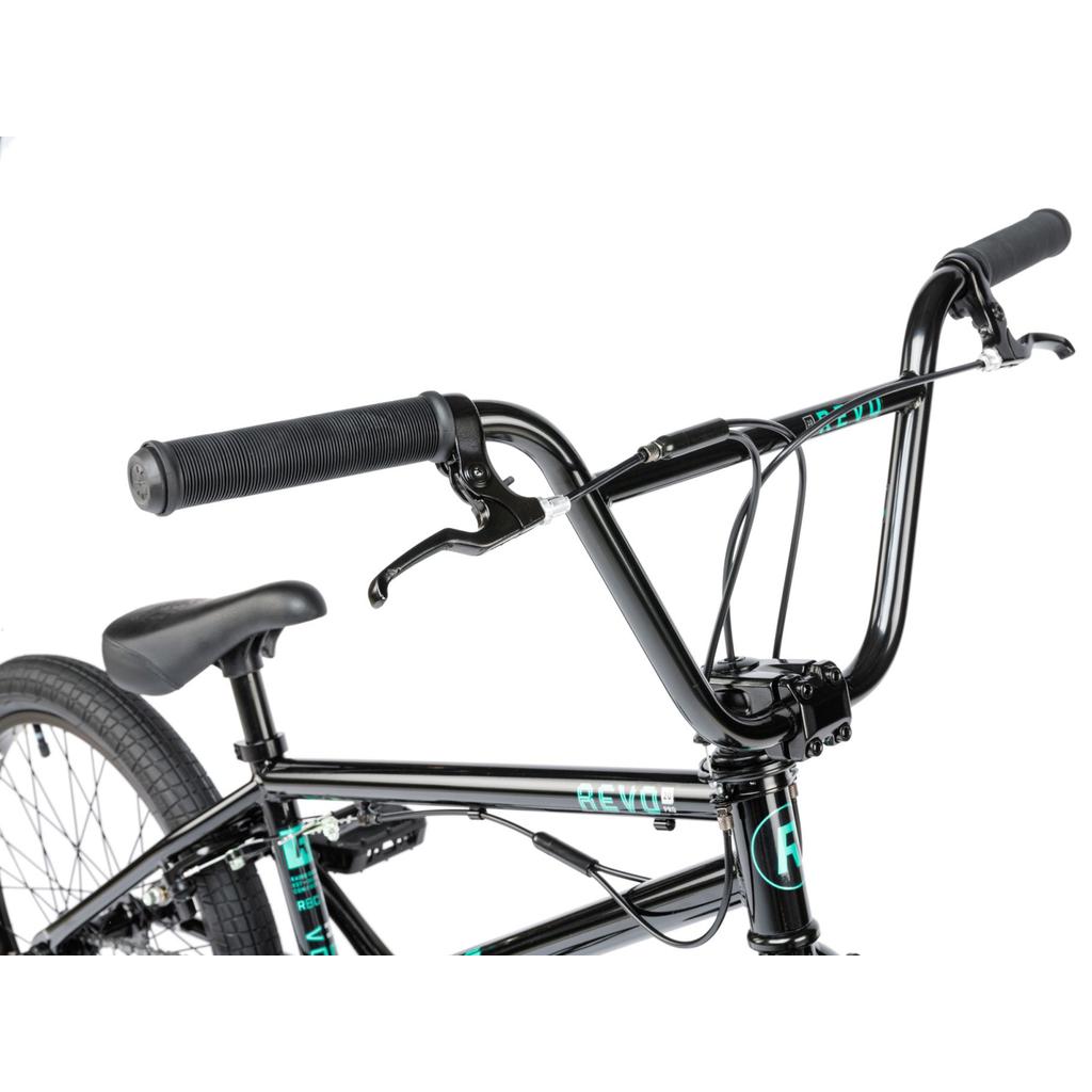 Close-up of the handlebars, brake lever, seat, gyro system, and part of the frame of a black Radio Revo Pro FS 20 Inch Bike against a white background.