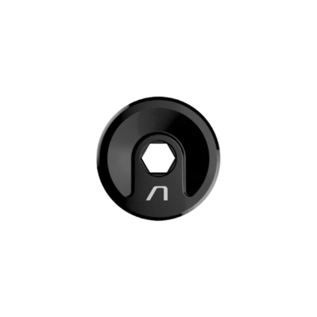 A black, circular CNC alloy Arise Terra Fork Preload Bolt (M18) with a central hex hole and a white marking near the edge, viewed from above. Designed as an M18 top cap, it's ideal for use with a Terra Pro fork.