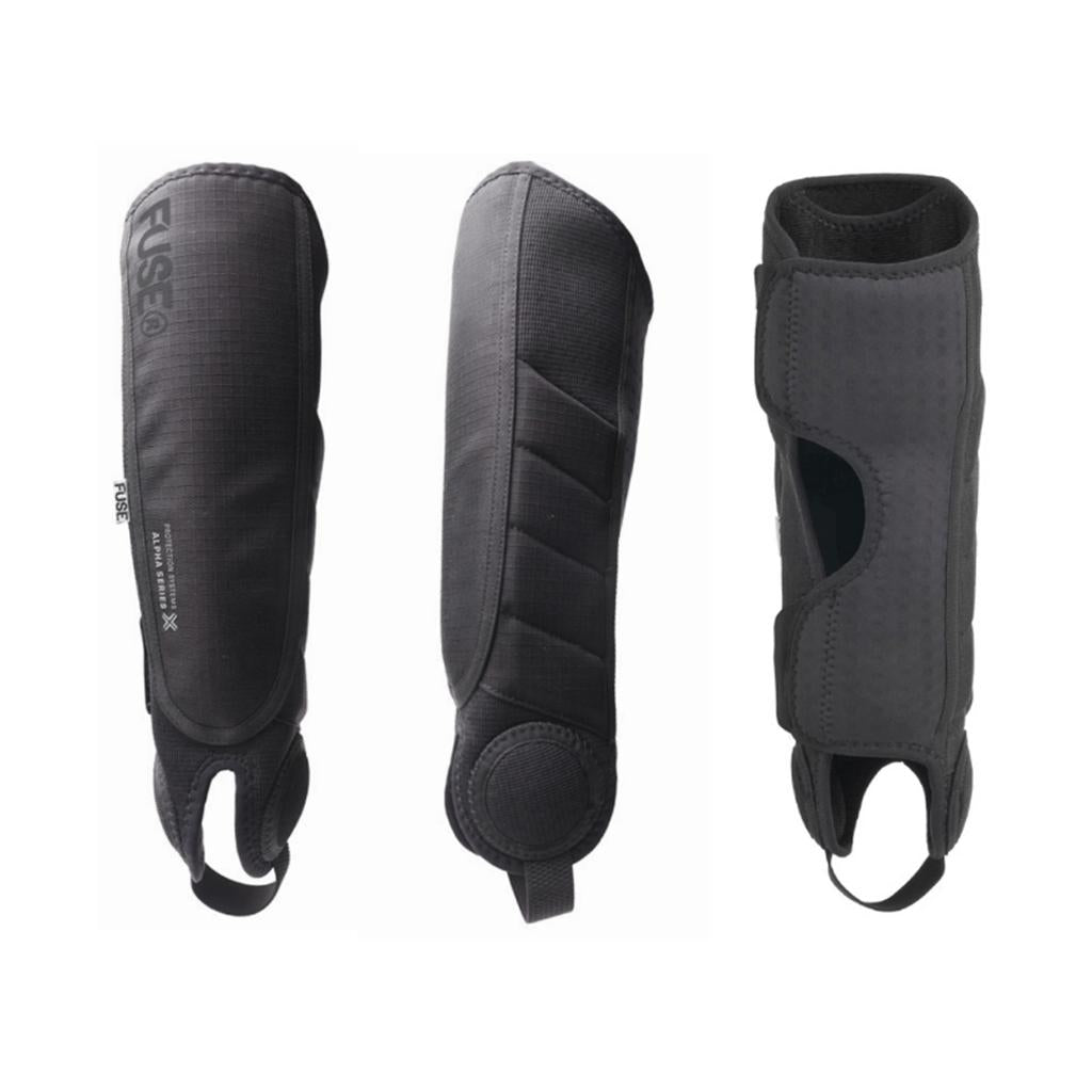 The Fuse Alpha Plus Shin/Ankle Combo Pads (Pair) are shown from different angles, featuring black padded design with straps and reinforced areas for optimal leg protection against a white background.