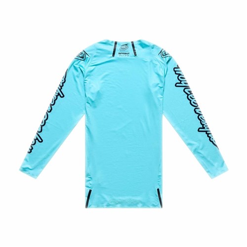 The TLD 26.1 Sprint Ultra Jersey / Mono Real Teal is a long-sleeve jersey in light blue Ultra Knit fabric, featuring black text graphics on both sleeves, displayed from the back against a white background.