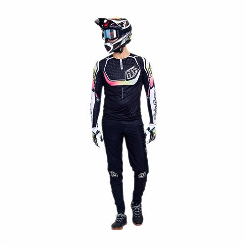 Person wearing a TLD 26.1 Sprint Ultra Jersey in Proton Black with helmet and goggles, standing and looking to the side against a white background.