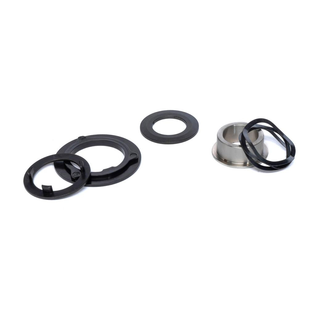 The Eclat Shift/WTP Hybrid Slack Disc Set, featuring black plastic rings, a metal cylinder, and rubber gaskets—perfect for Eclat Shift or WTP Hybrid hub setups—is arranged on a white background.