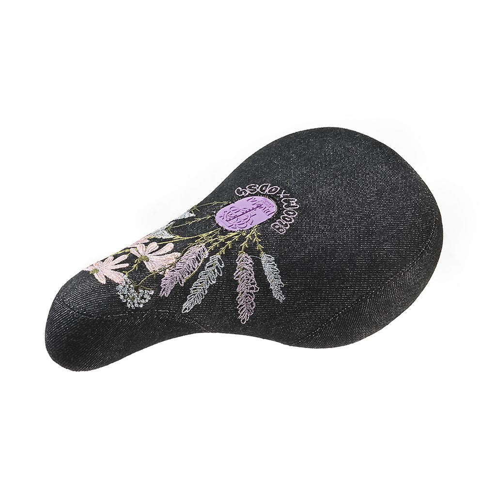 A black Odyssey Bloom Pivotal Seat with an embroidered design of purple and pink flowers and green leaves, isolated on a white background.