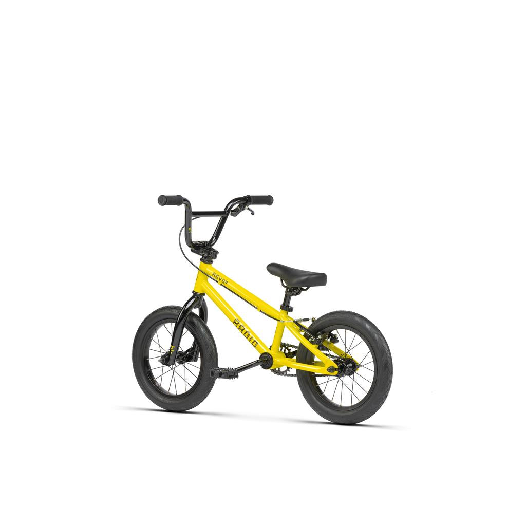 The Radio Revo 14 Inch bike, shown on a white background, is a small yellow BMX children's bike with black handlebars, seat, and tires—ideal as a first bike.