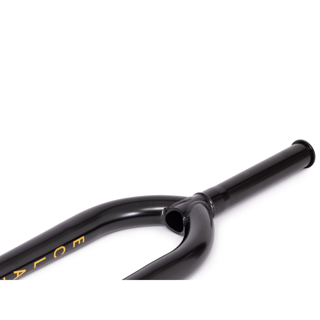 A close-up of a black Eclat Storm XLT Fork made from 4130 Chromoly, featuring yellow lettering, isolated on a white background.