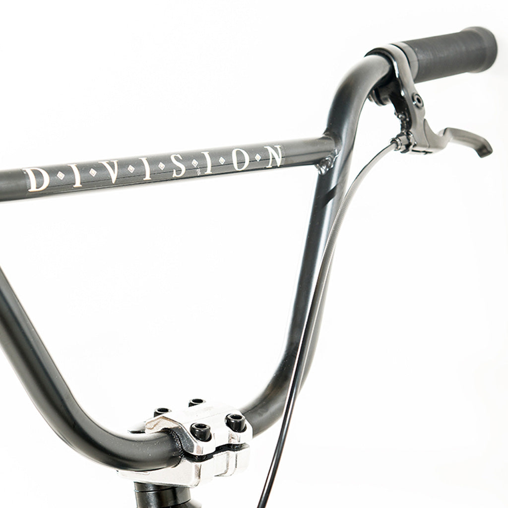 A close up of a Division Reark 20 Inch Bike with the word Division on it.