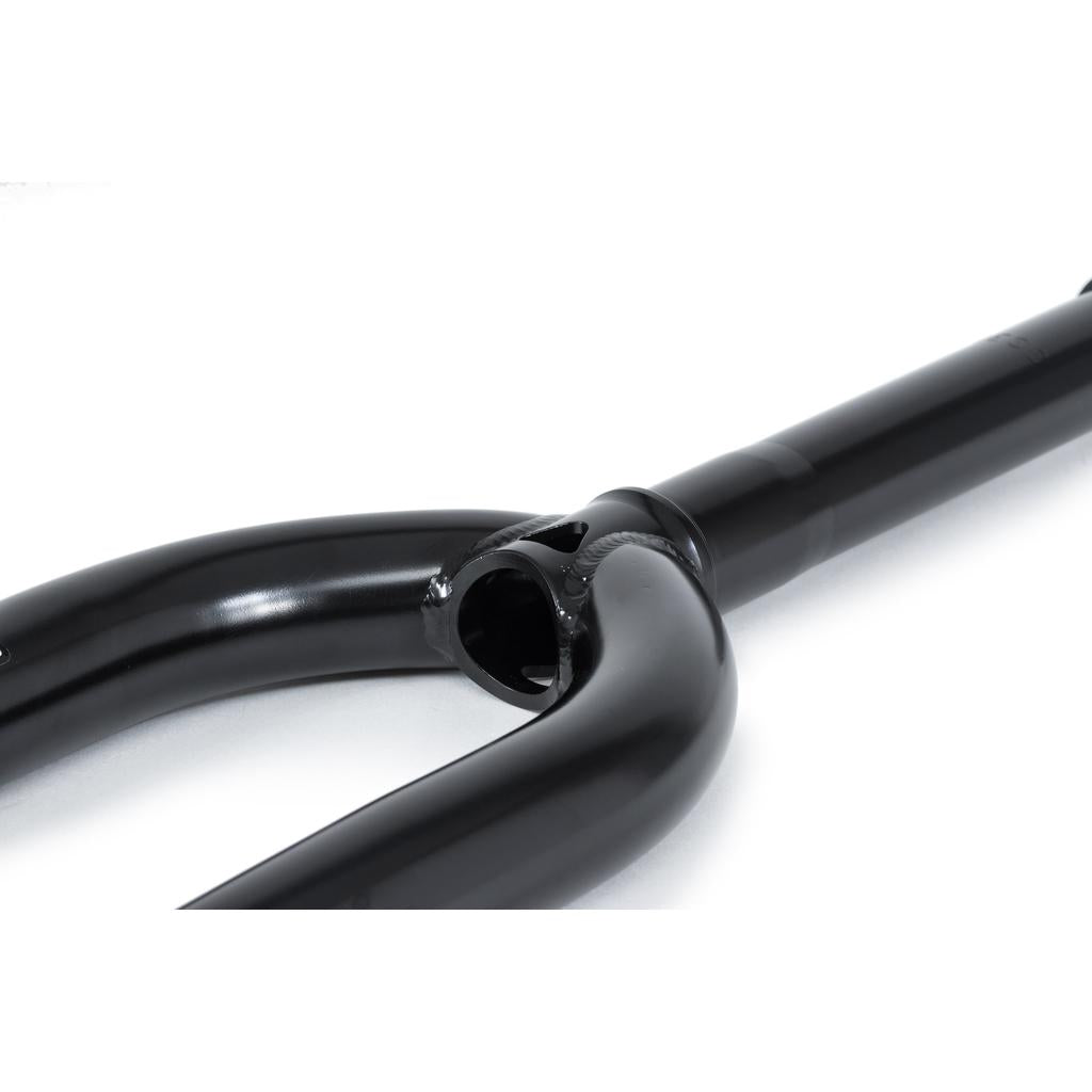 Close-up of the Wethepeople Message Fork, a super tough black bicycle fork with a smooth finish and visible welds, designed for park riders, against a white background.