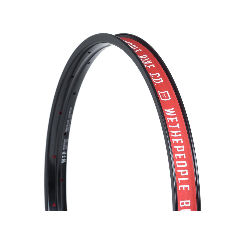 Close-up of a high quality Wethepeople Logic 22 Inch Rim, 36H, in black with red and white "WETHEPEOPLE BIKE CO." branding and model details inside, made from durable 6069-T6 alloy.